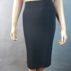 Bebe just below knee Small black skirt.  5" hem slit on both sides